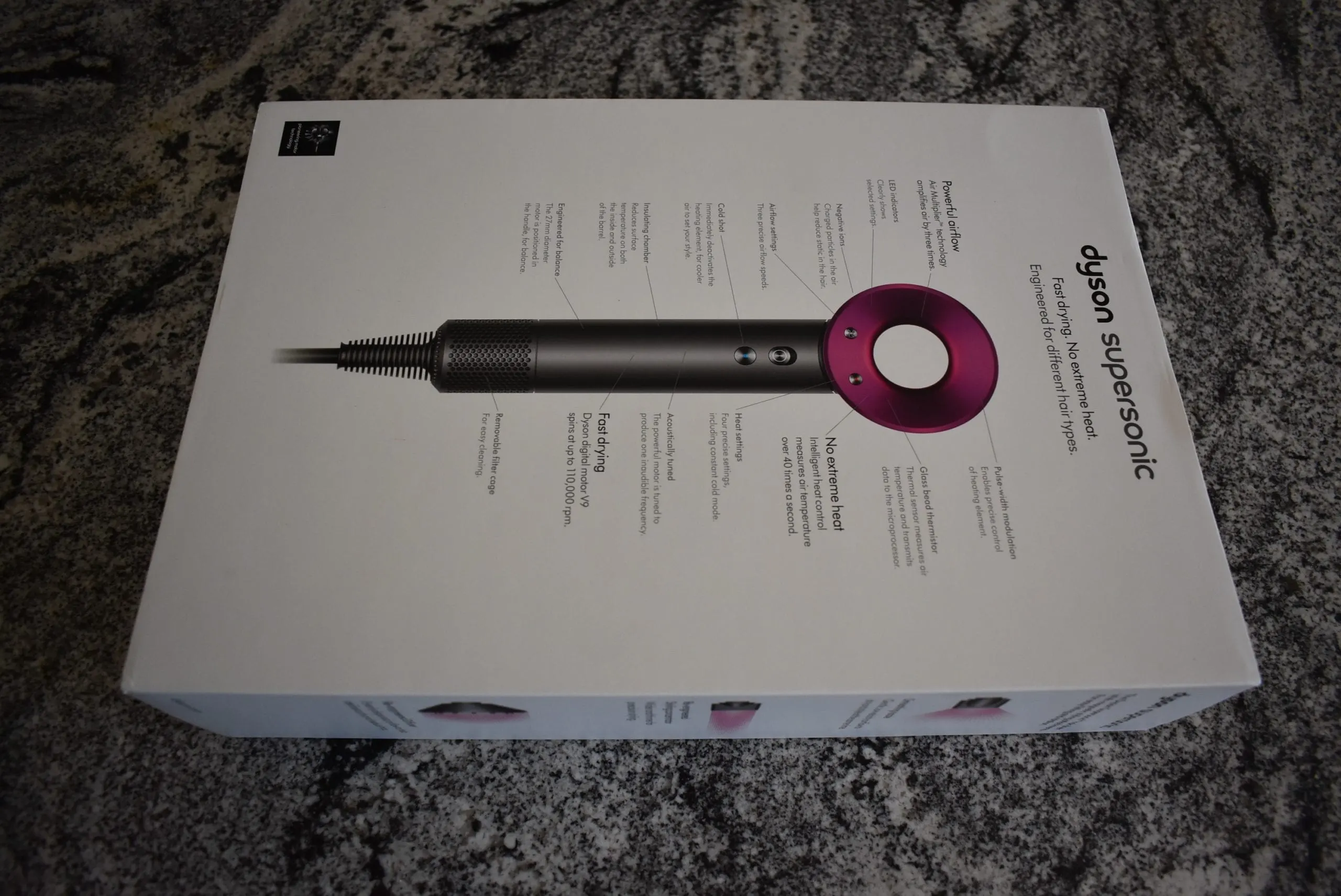 For a dyson hair dryer review, the retail box sits on a granite counter
