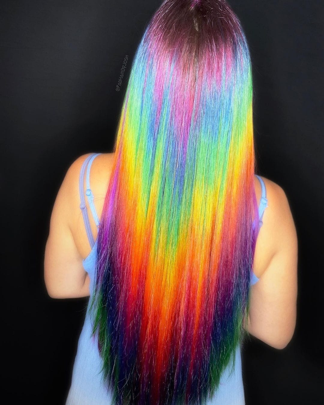 Holographic spectrum hair with bright shades of yellow and orange and muted blue and purples
