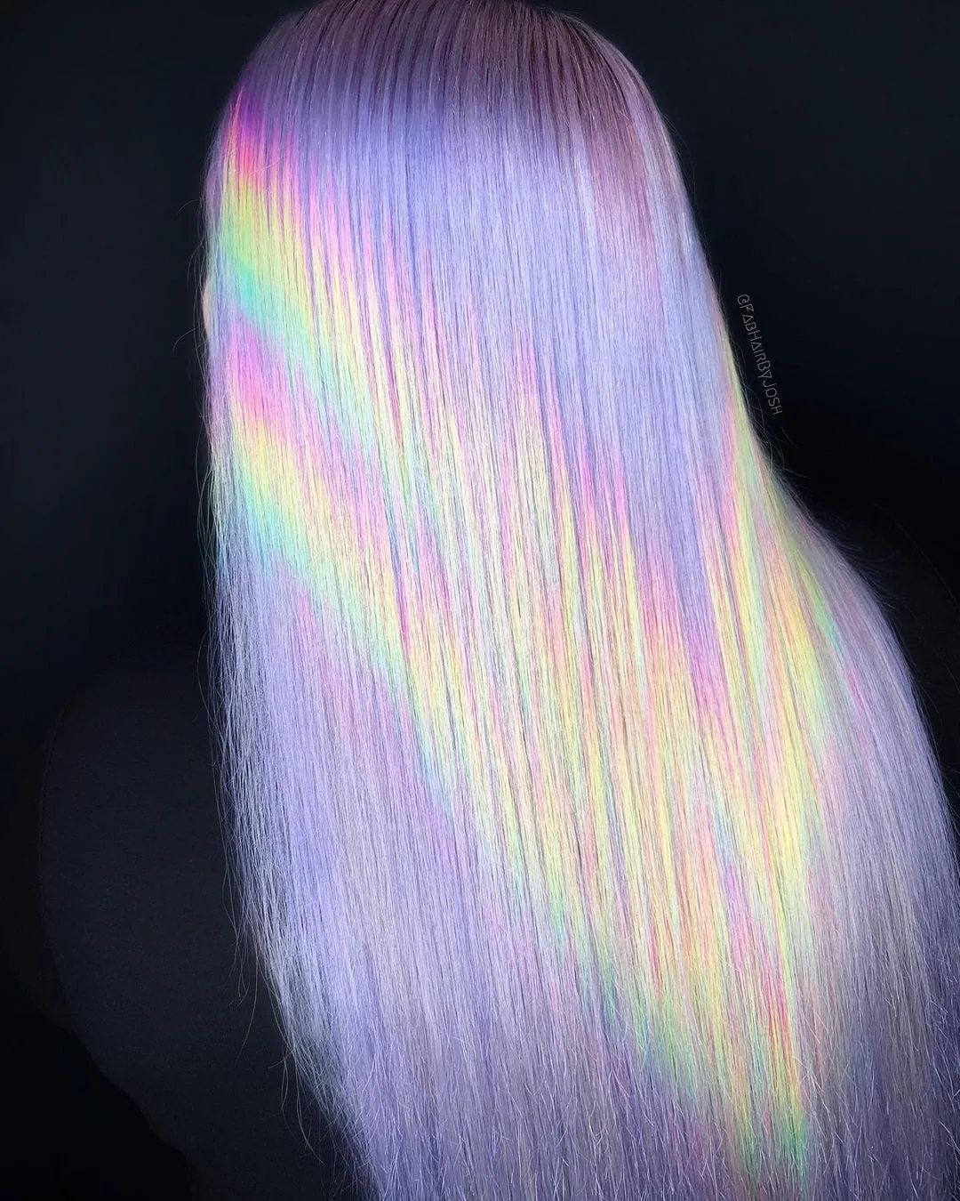 Lavender holographic hair with mainly purple coloring with lines of yellow and orange