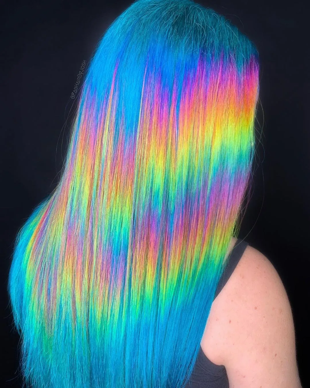 Ocean halographic hairstyle featuring wave and sunset-like hair against black background