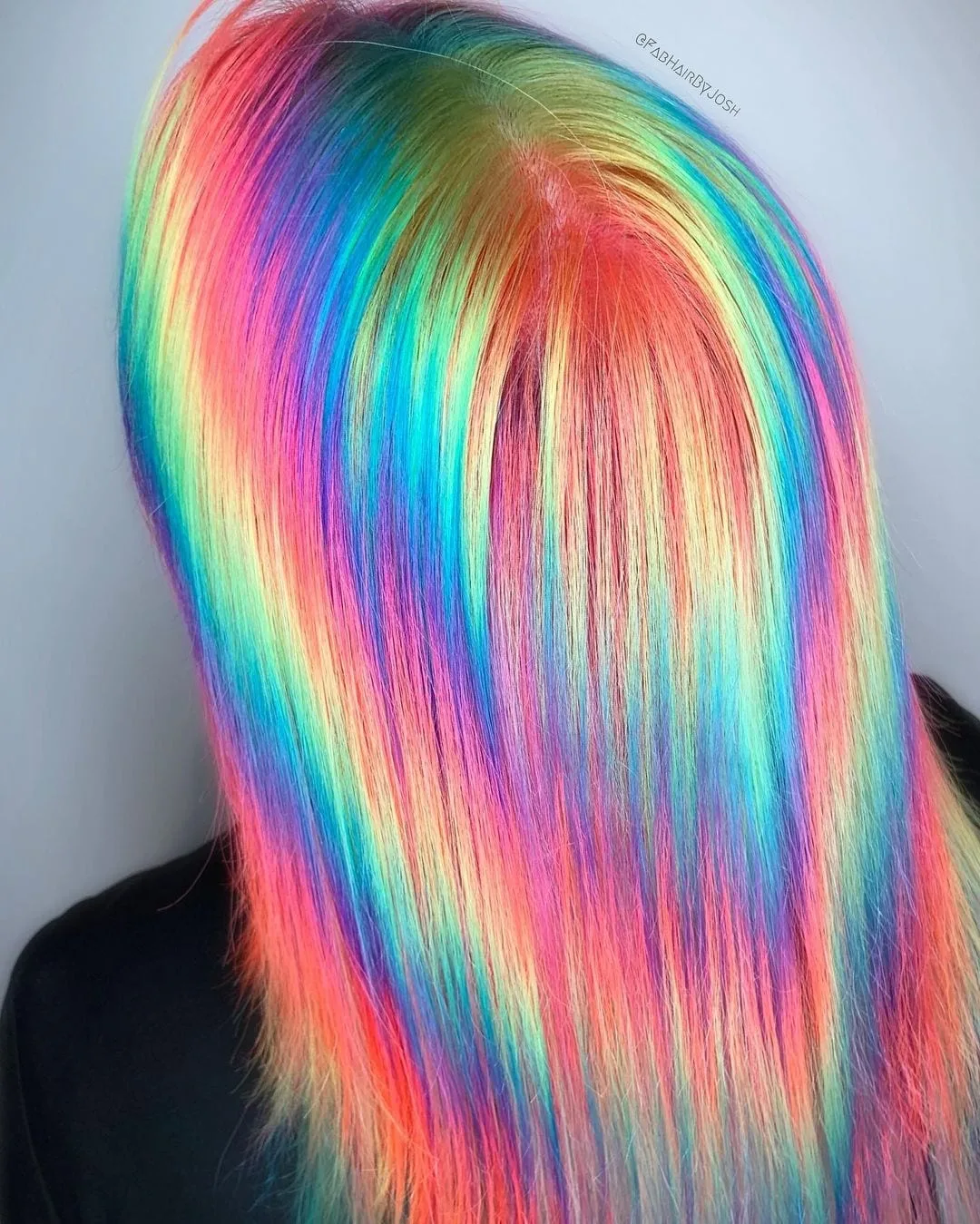 Crazy psychadelic holographic hairstyle on a woman with a cropped haircut that sits at her shoulders