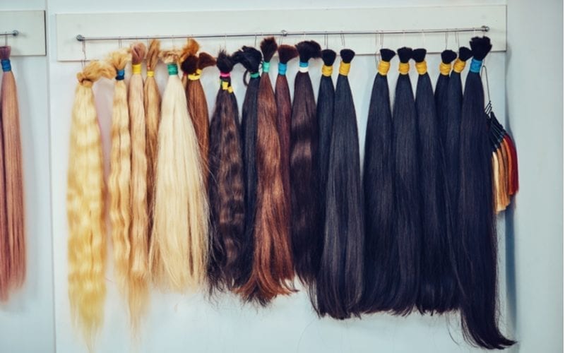 A bunch of weave hairstyles primed to attach to a luck woman's head