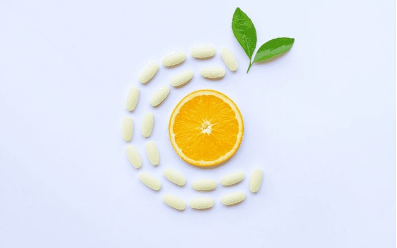 Using vitamin c to remove hair dye naturally featuring a lemon in the middle of a C made out of pills