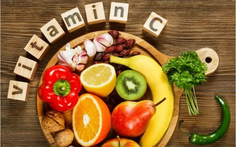 Various foods containing vitamin c in a lay-flat image for a piece on best vitamin for hair