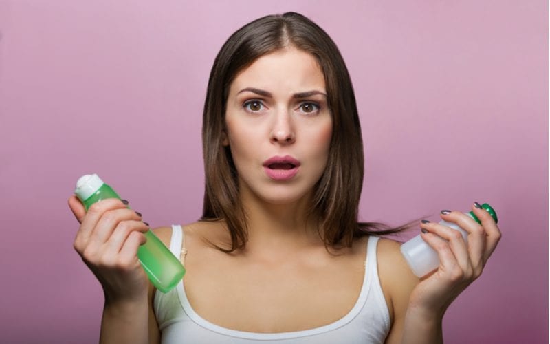 Woman who is confused because with so many choices, it's hard to learn about the best products for curly hair. Our guide helps.