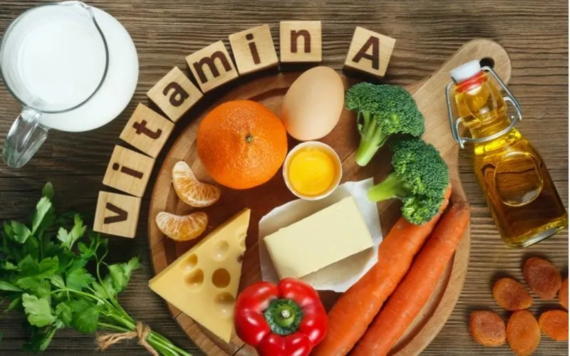 Lots of vitamins sitting on a wooden table for a piece on which vitamins are good for your hair