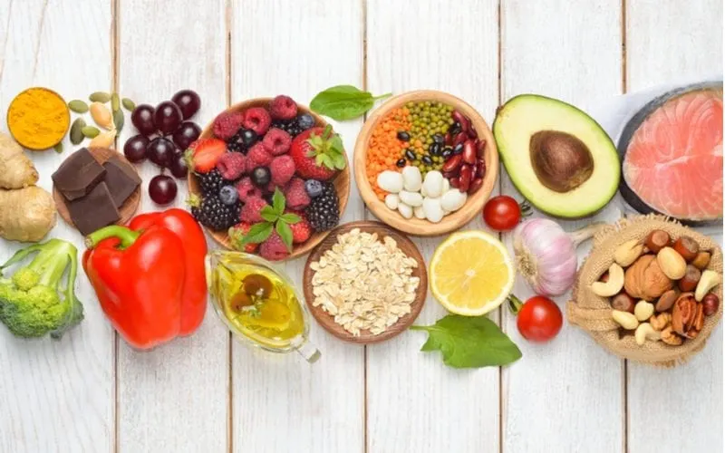 For a piece on how to make your hair grow faster, an image of a bunch of healthy food sits on a shiplap table