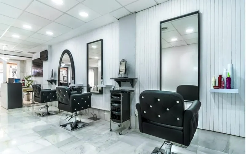 For a piece on Regis hair salon prices, the bright interior of a modern white-walled hair salon