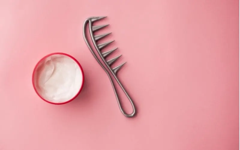 Under the heading What Is Hair Milk sits a wide-toothed comb and a bowl of hair milk against a pink background