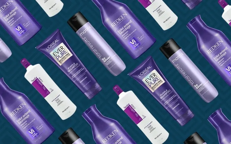 Purple shampoo products spread out against a blue background
