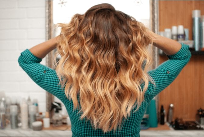 Lady with Ombre hair for a piece on what is Ombre holding her locks up so they don't touch her shoulders