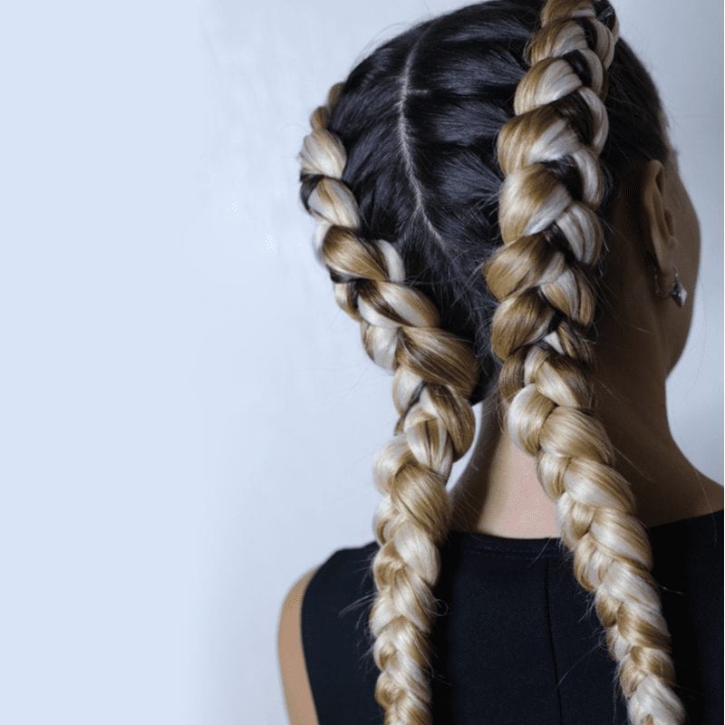 For a piece on types of braids, a sporty double dutch braid on a woman with dark hair
