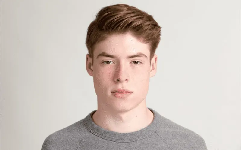 Quiff Fade With Side Part on a kid in a grey shirt