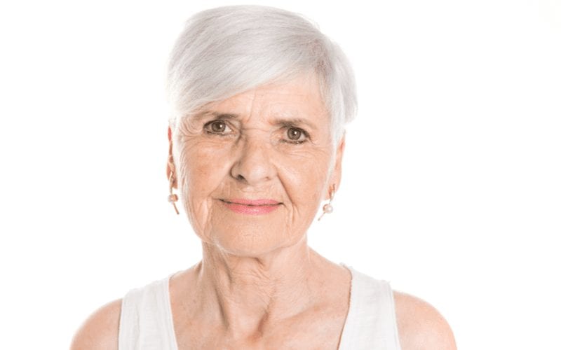 Lady with a brushed-forward pixie short haircut for women over 60