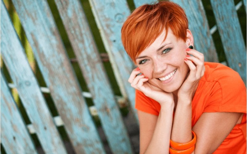Woman wearing a red Ginger-Tinted Pixie haircut