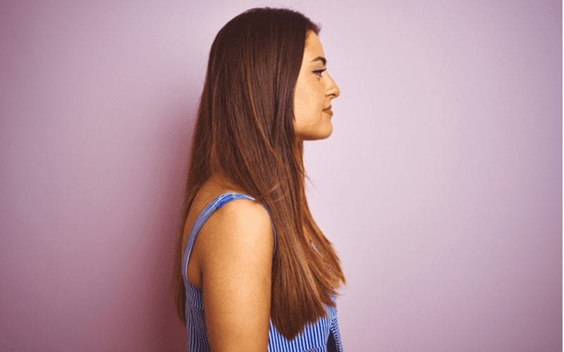 Side profile of a woman with Short Layers in a blue striped shirt