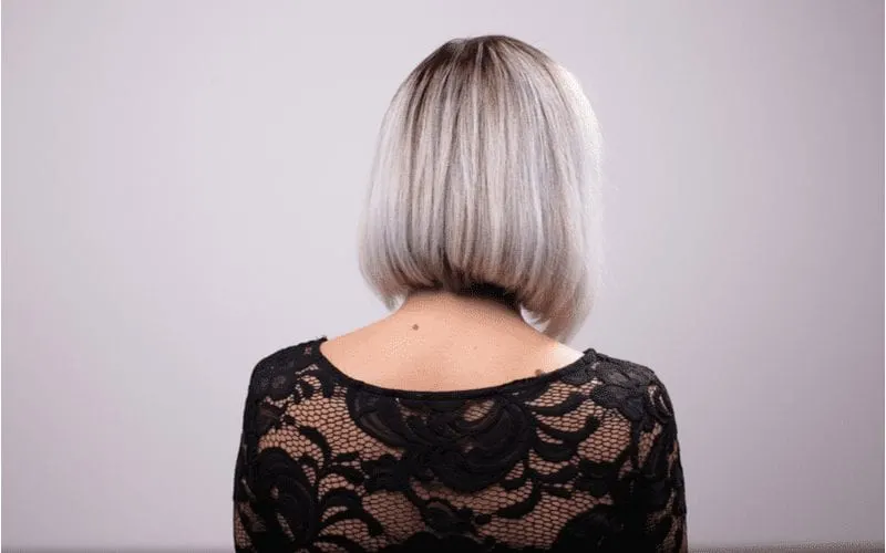For a post on what is a lob haircut, a silver haired woman looks away and you can only see her shoulders and upper back