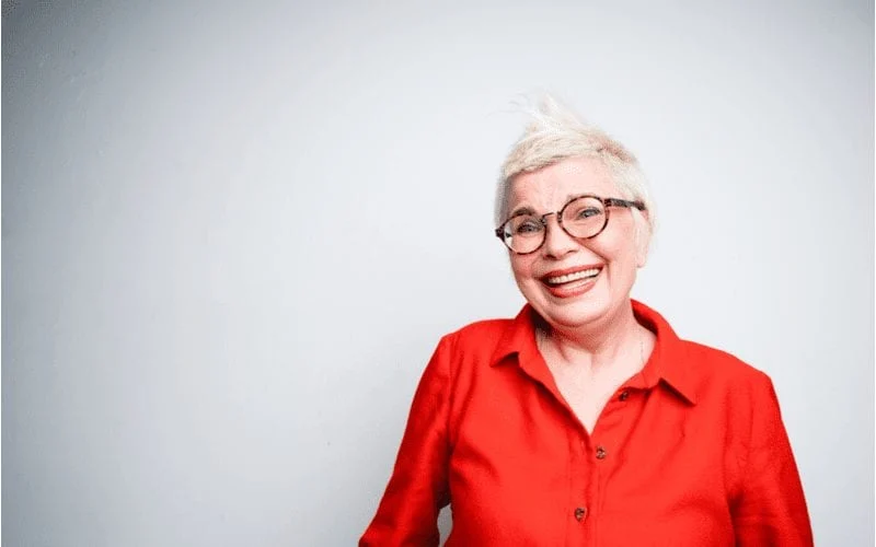 Woman in a red shirt with a haircut for women over 60 as a pixie