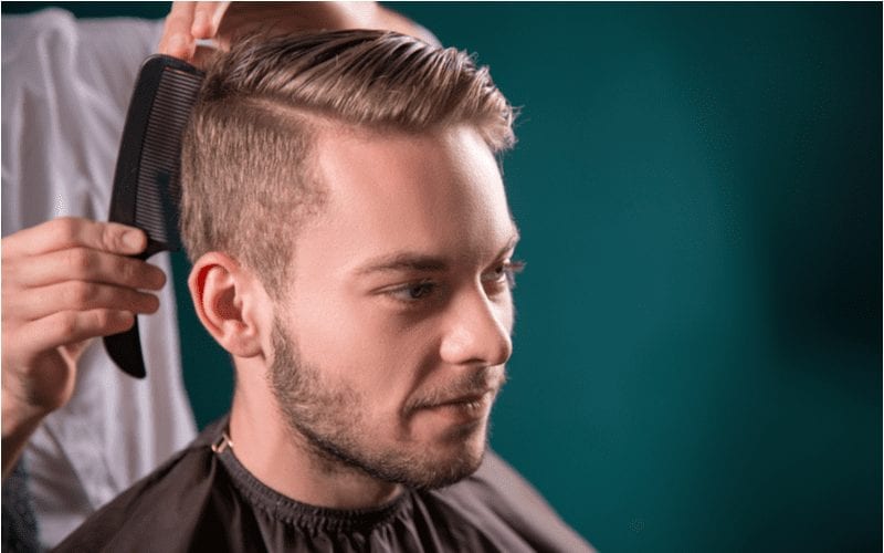 Man with a short mens haircut featuring long sides and a short top