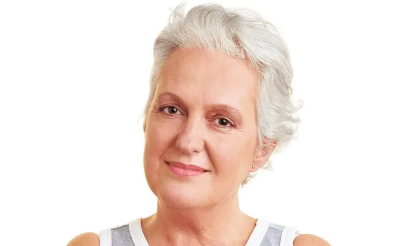 Crop With Slicked-Back Bangs on an older woman crossing her arms