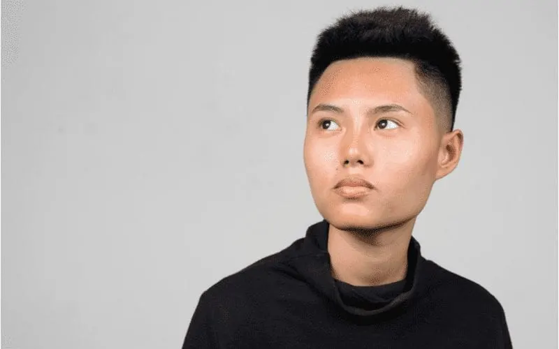 Asian man with a Styled-Up High Fade looks upward