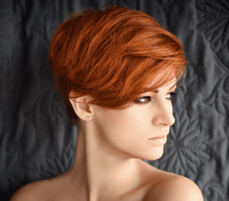 Lady with a dark copper crop stands looking to her right for a piece on red hair inspiration