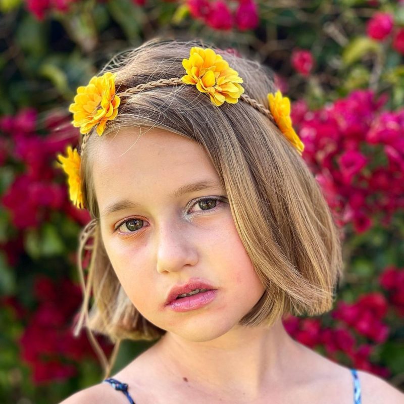 Young woman with yellow flowers on her head for a piece on toddlers braided hairstyles
