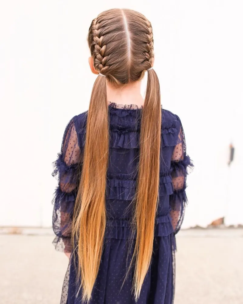 On picture day, a girl wears a popular toddler braided hairstyle with french braids that flow into long unbraided hair