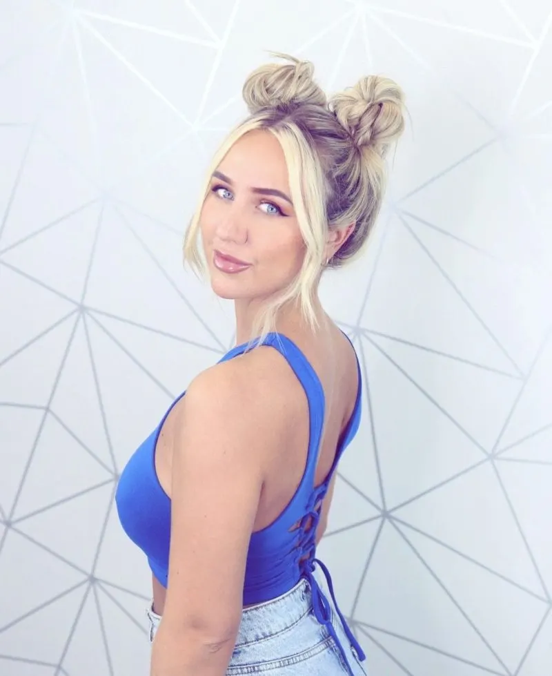 Blonde space buns on a girl in a summertime blue button-up corset crop top