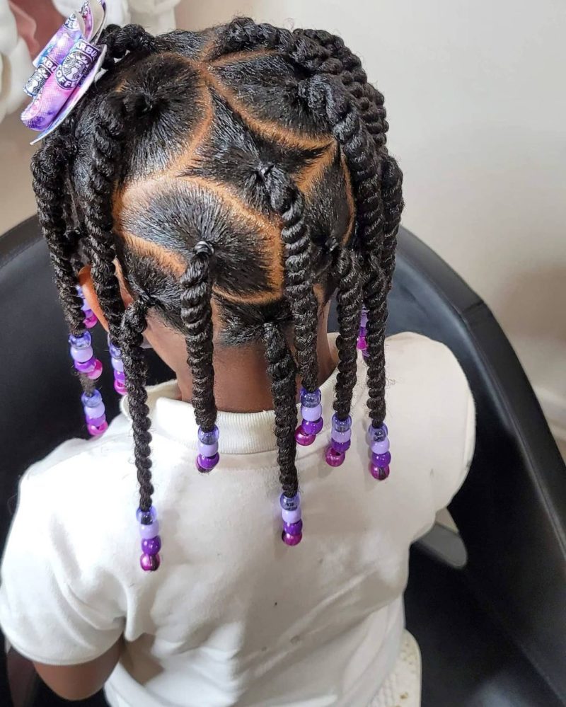 Sparse box braids with beads on the end and a bow