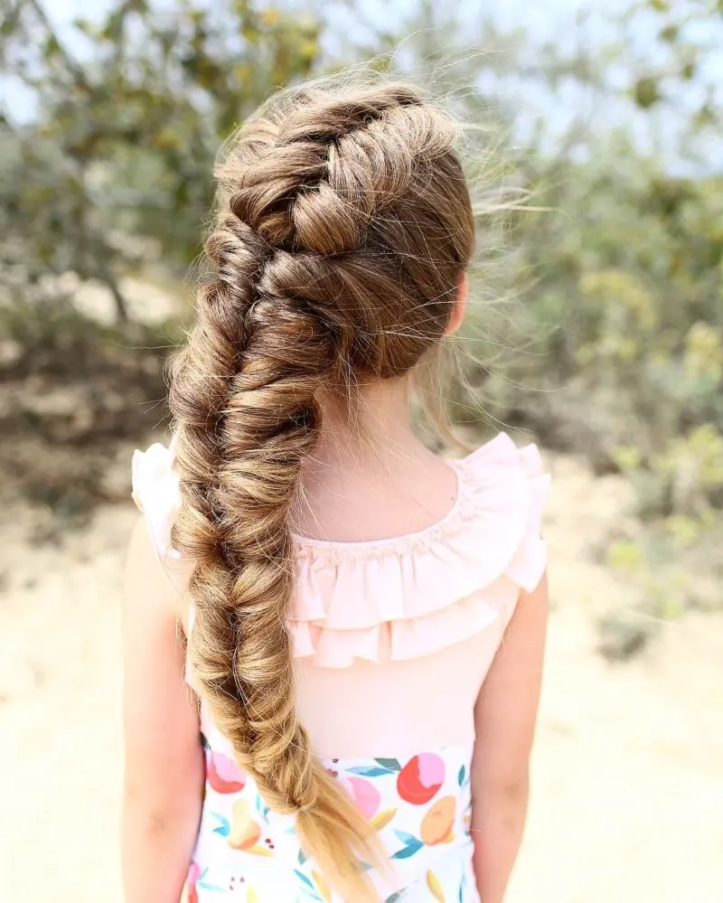 girl with a toddlers braided hairstyle with a textured big braid