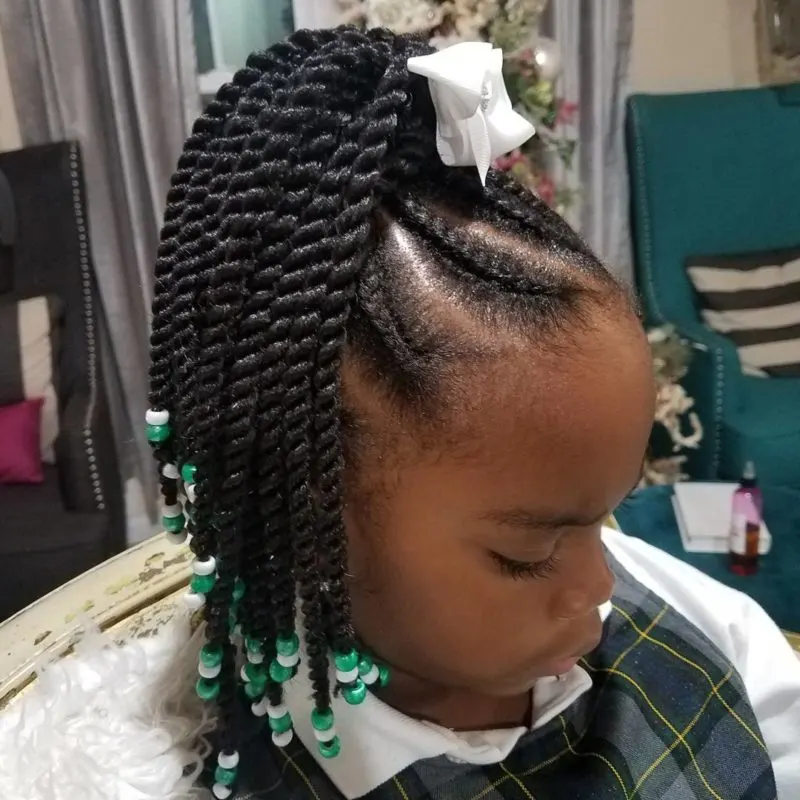 Girl with a braided updo for a piece on toddlers braided hairstyles