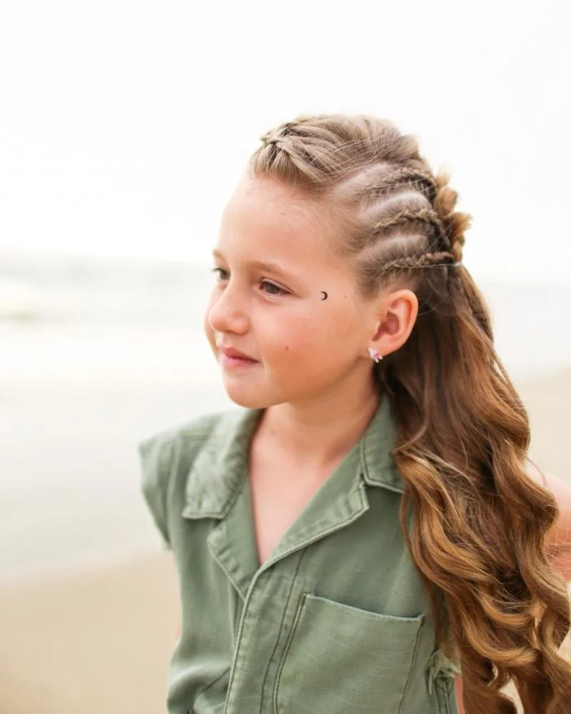 Young gal with side braids that flows into a flowing hairstyle
