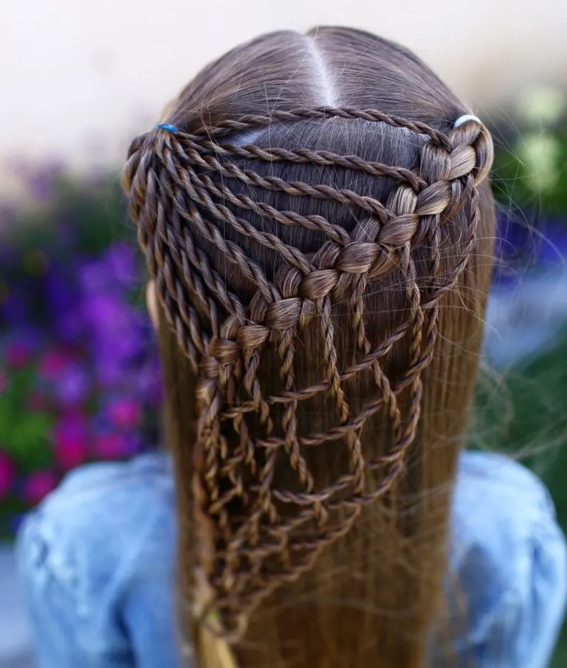 Fishnet braids on a young gal in a jean jacket as an example of a toddler braided hairstyle