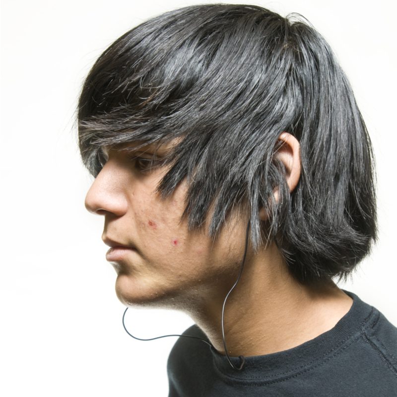 Forward combed-over emo hair on a guy in a black dragon shirt