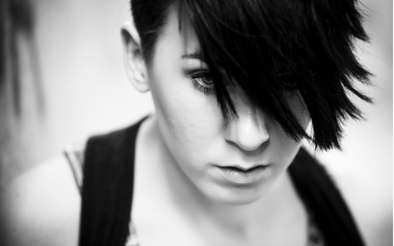 Girl with extreme emo hair with swoopy front bangs in a black and white image