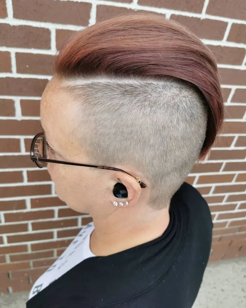 High and tight female mohawk on a woman with slicked back hair and a major and complete fade