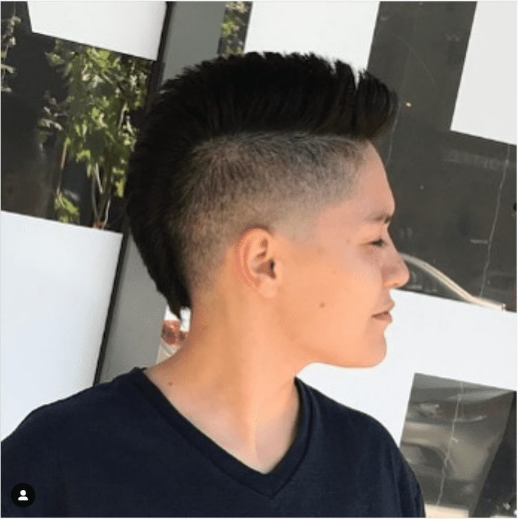Woman with a female mohawk haircut in a side profile image