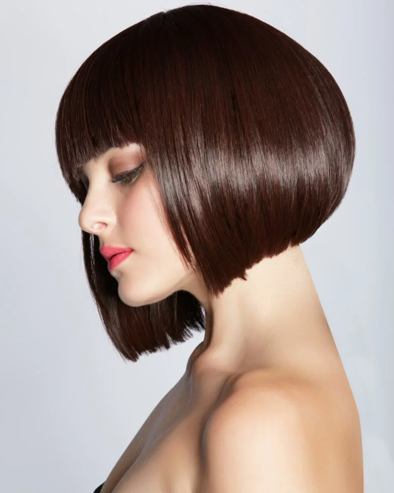 Model wearing pink lipstick wearing an asymmetrical stacked and slanted bob haircut