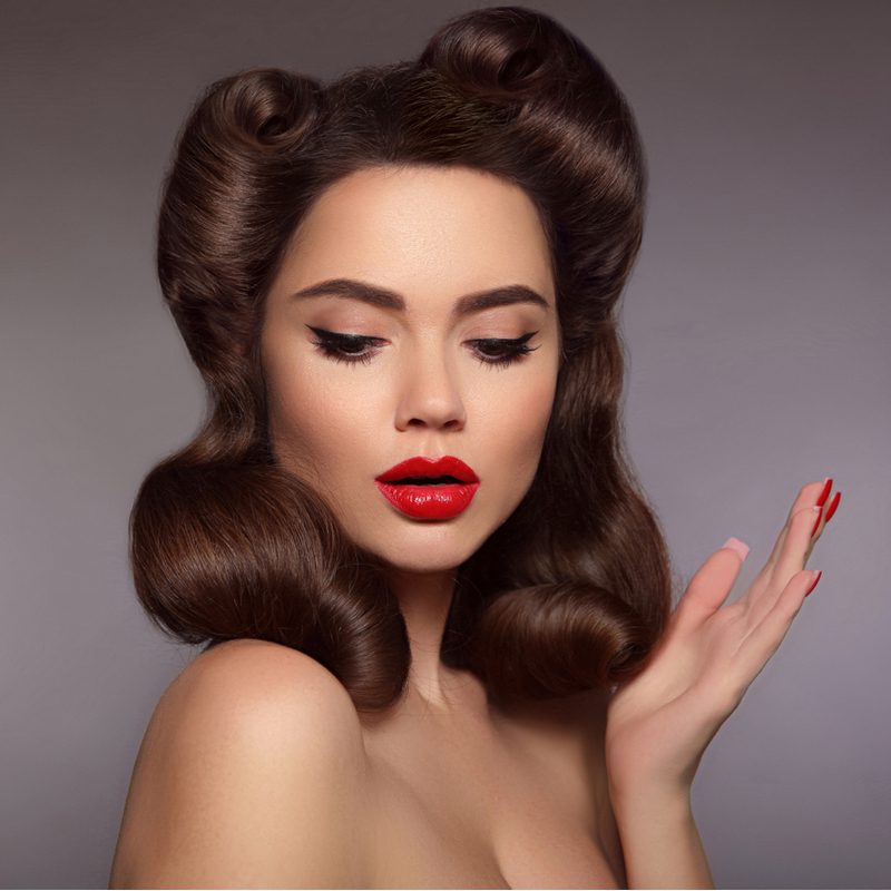 Simple rolled mother of the groom hairstyle on a retro-looking woman in red lip