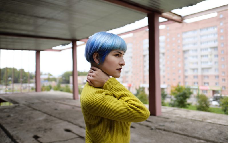 Icy Blue Cropped Bob on a woman in a lime green sweater standing on a roof