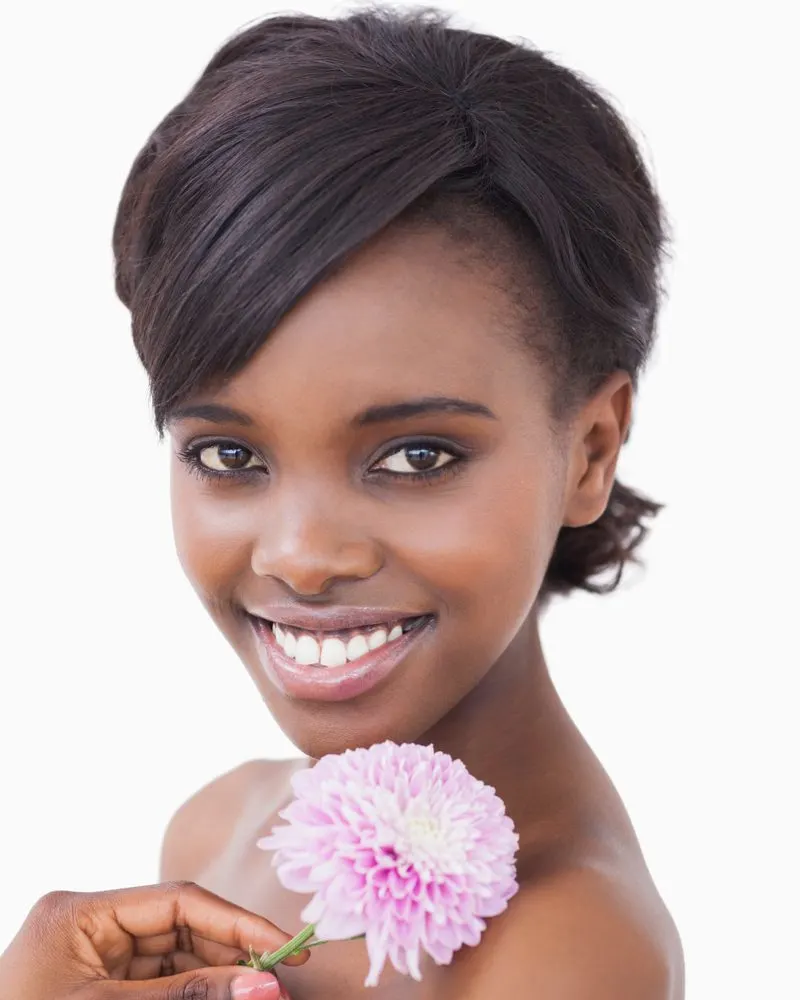 Relaxed Bob With Side Bangs on a black woman holding a purple flower