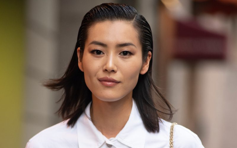 Pretty Asian model with a slicked-back choppy long bob haircut walks on the runway in Milan