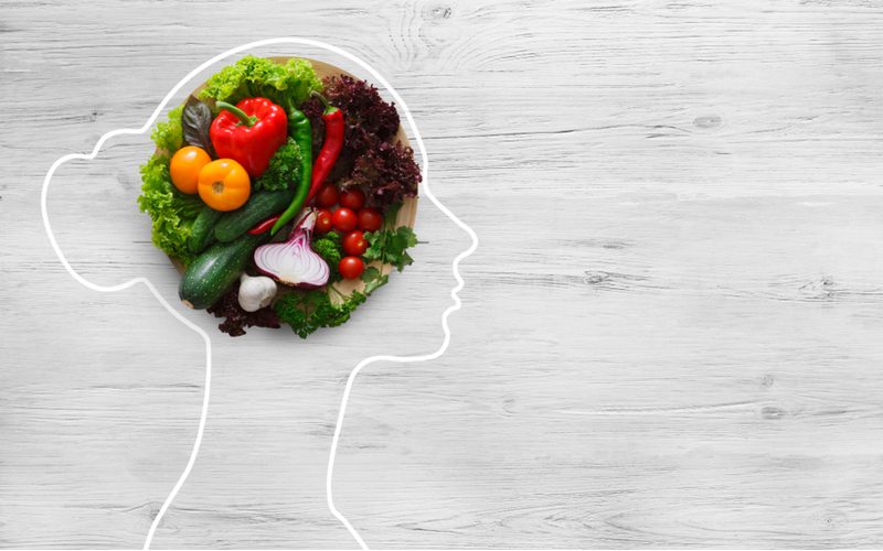 To symbolize why nutrition plays a big part in how long bangs take to grow out, a chalk outline of a woman with vegetables and fruits in her head