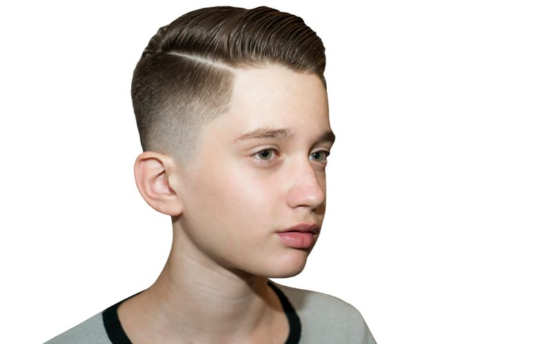 Dapper looking young European kid with a shaved side-part low fade haircut