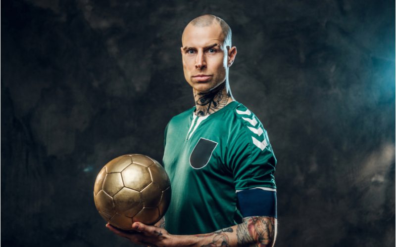 The Buzz for Balding Hairstyle on a guy holding a soccer ball