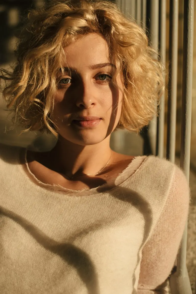 Boho Air-Dried Curly Bob on a woman in a sweater with droopy eyes