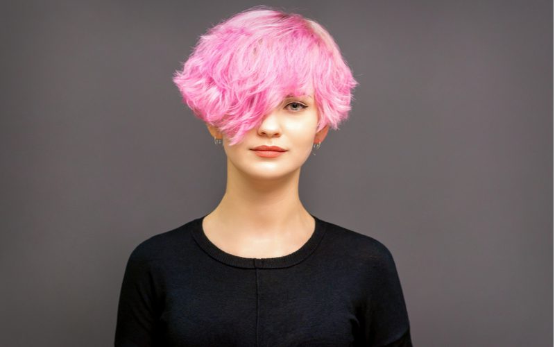 Bubblegum Stacked Short Bob Haircut in pink on a woman in a black shirt