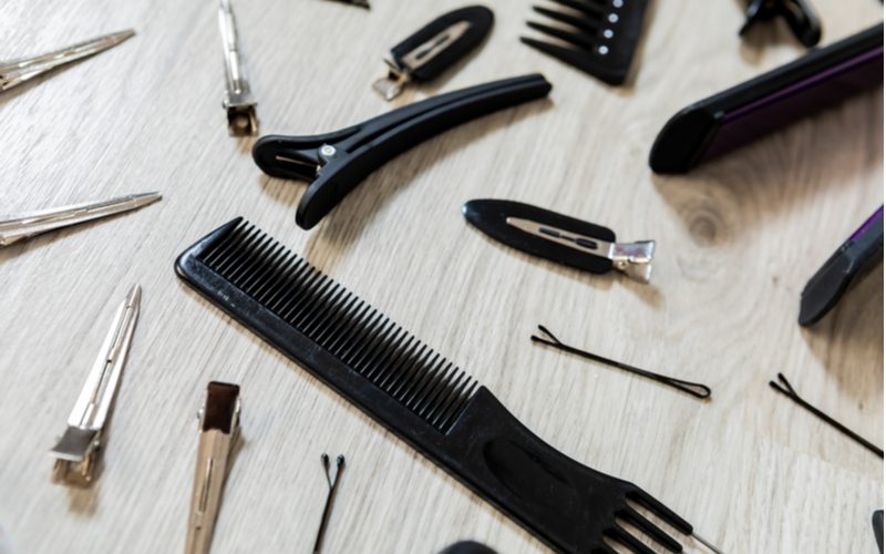 A bunch of hair care tools that represent factors that affect how long it takes for bangs to grow out