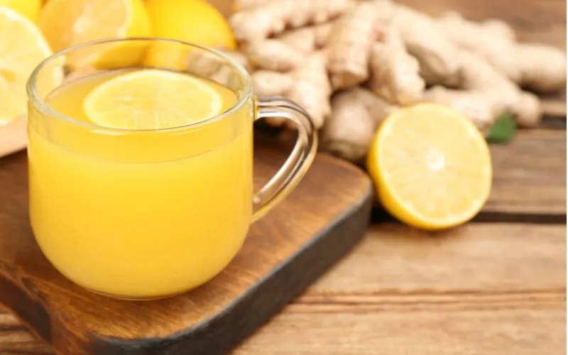 Lemon juice sits on a wooden table as a method to lighten hair without bleach